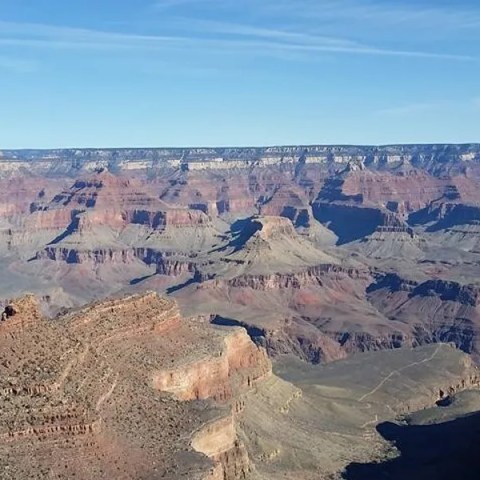 Panoramic view of the Grand Canyon with clear blue sky.