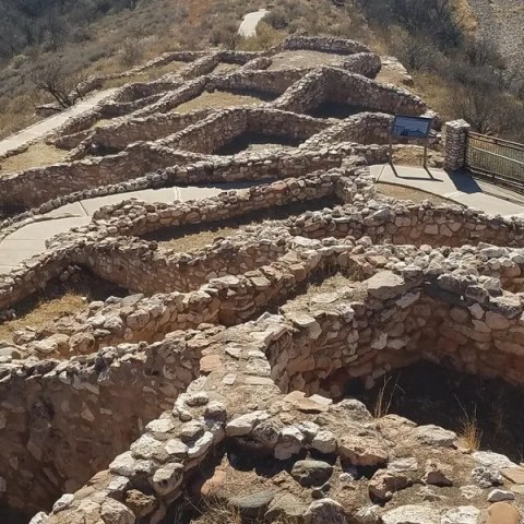 Aerial view of ancient stone ruins on a hillside path.