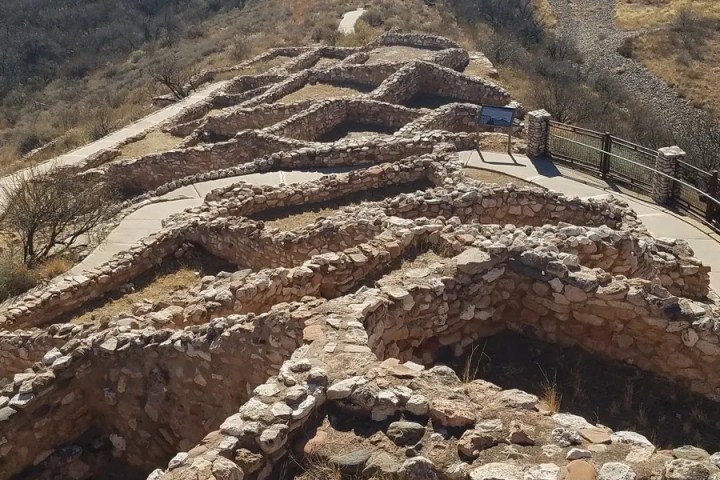 Aerial view of ancient stone ruins on a hillside path.