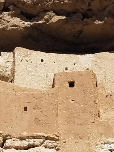 Ancient cliff dwelling built into a rocky cliff face.